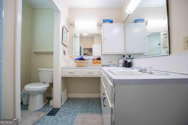 bathroom featuring vanity, ornamental molding, and toilet