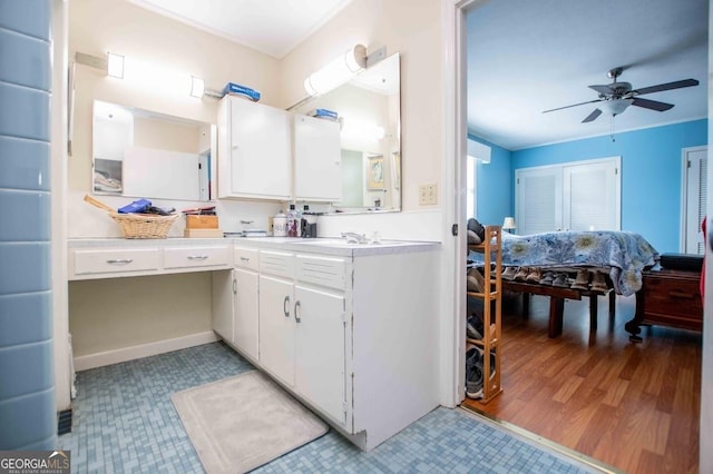 bathroom with vanity, crown molding, and ceiling fan