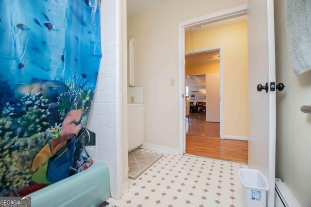 bathroom featuring a baseboard radiator and shower / tub combo