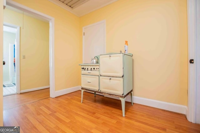 miscellaneous room with ornamental molding and light hardwood / wood-style floors