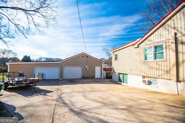 view of side of home featuring an outbuilding and a garage