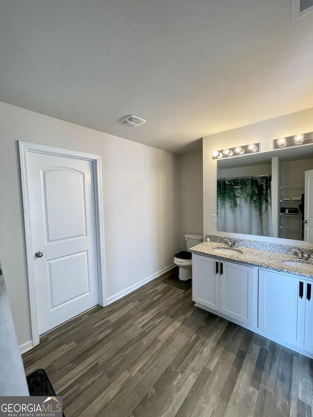 bathroom featuring a shower with curtain, vanity, toilet, and hardwood / wood-style floors