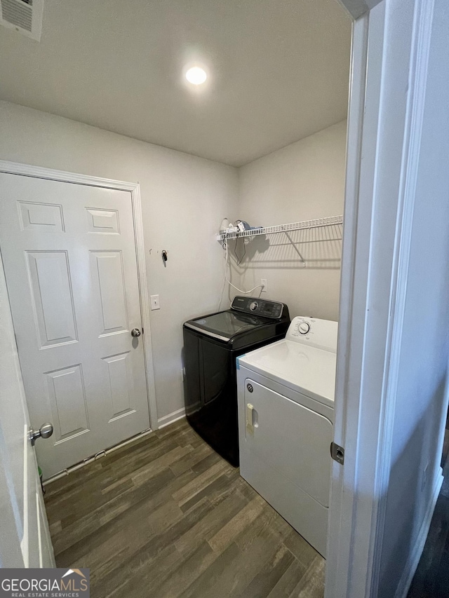 laundry room featuring washing machine and dryer and dark hardwood / wood-style floors