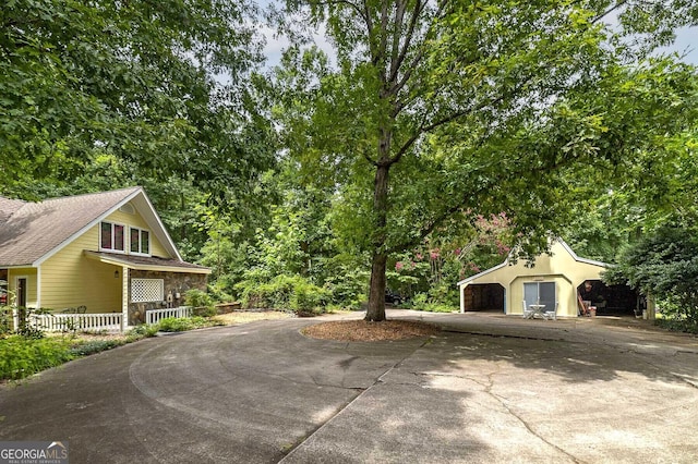 view of side of property with a garage and a porch