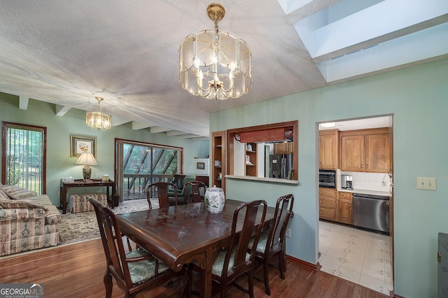 dining room featuring a textured ceiling, light hardwood / wood-style flooring, and a chandelier