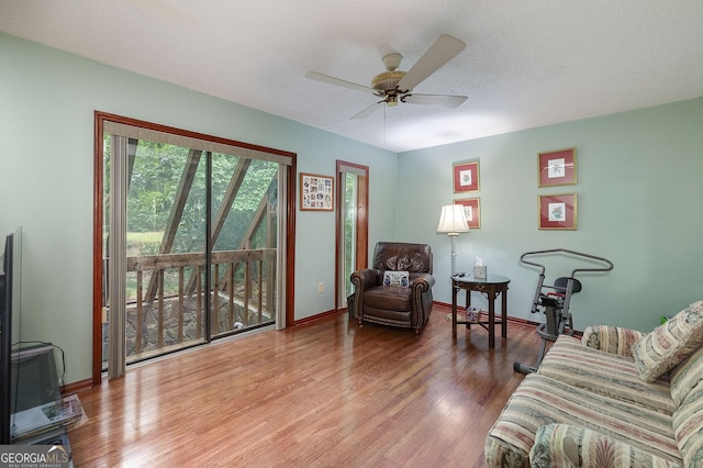 living room featuring hardwood / wood-style floors and ceiling fan