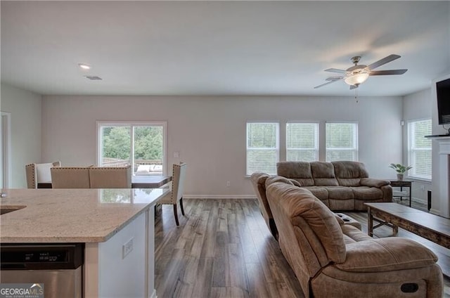 living room featuring ceiling fan and light hardwood / wood-style flooring