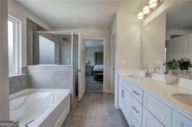 bathroom with vanity, tile patterned floors, and shower with separate bathtub