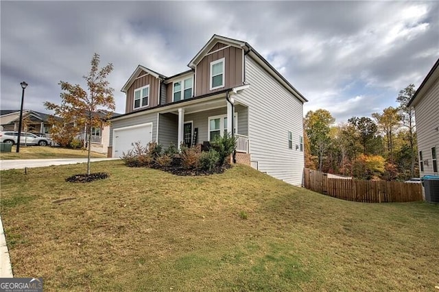 view of front of property featuring a garage, a front lawn, and a porch