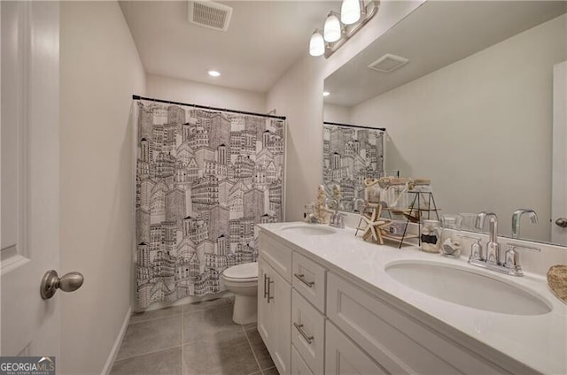 bathroom featuring tile patterned flooring, vanity, curtained shower, and toilet