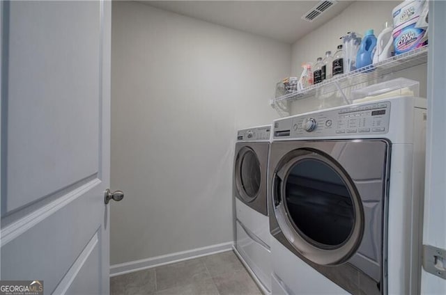 laundry area featuring independent washer and dryer and tile patterned floors