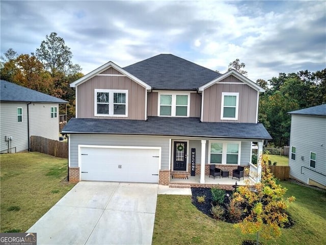 craftsman-style house featuring a garage, a front yard, and covered porch