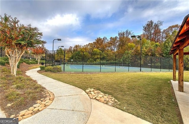 view of sport court with a yard