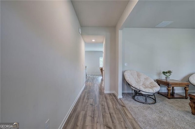 hallway with light hardwood / wood-style floors