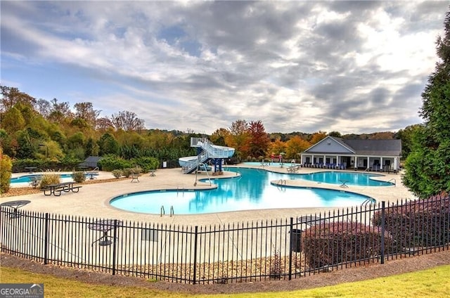 view of pool featuring a patio area and a water slide