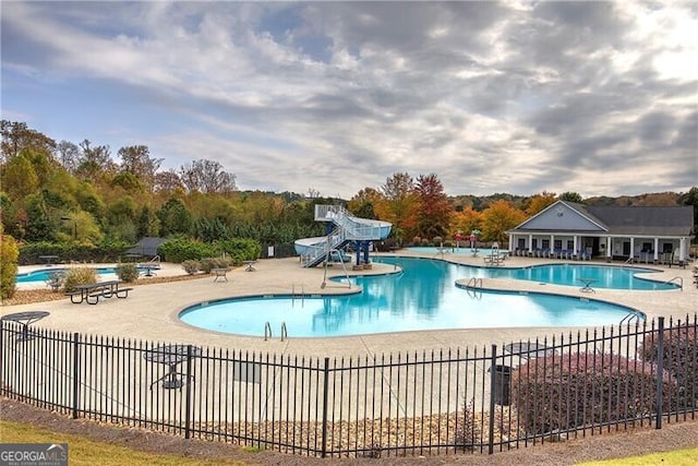 view of pool featuring a patio and a water slide