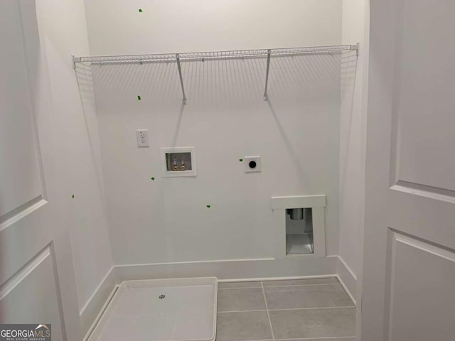 washroom featuring hookup for a washing machine, gas dryer hookup, tile patterned flooring, and hookup for an electric dryer