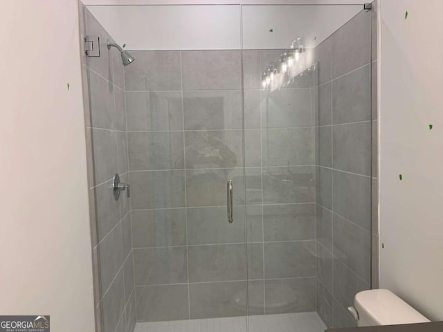 bathroom with toilet and walk in shower