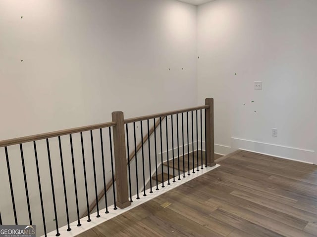 stairs featuring hardwood / wood-style flooring