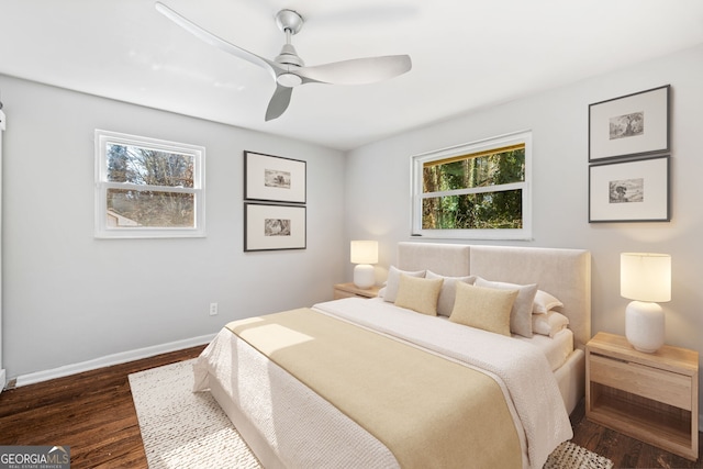 bedroom with ceiling fan and dark hardwood / wood-style flooring