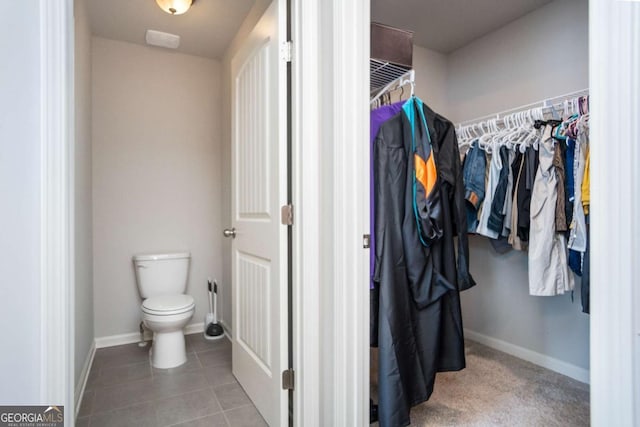 bathroom with tile patterned flooring and toilet