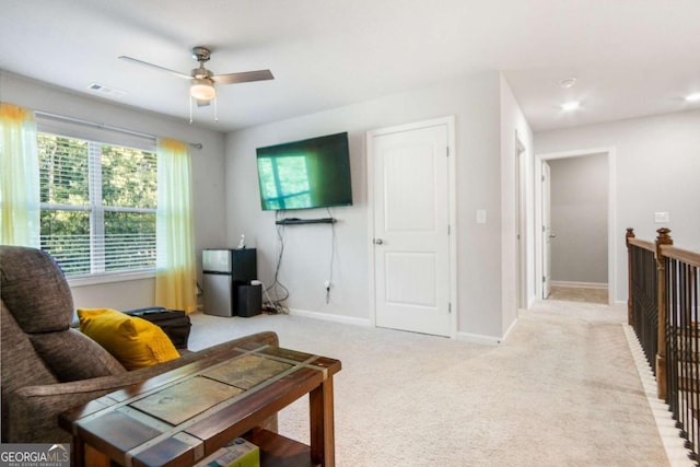 living room featuring light colored carpet and ceiling fan