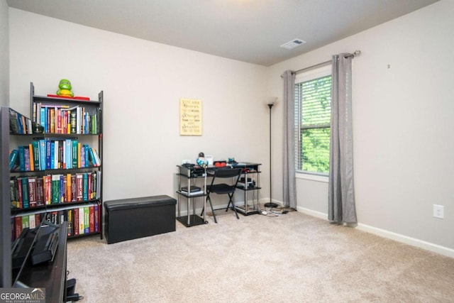 office area featuring light carpet