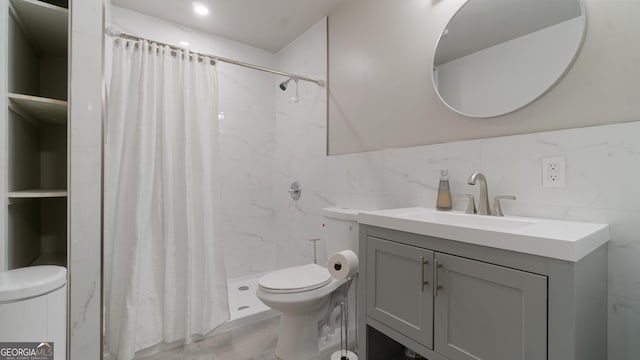 bathroom with vanity, a shower with curtain, tile walls, and toilet