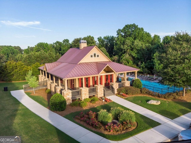 view of front of property featuring covered porch and a front yard