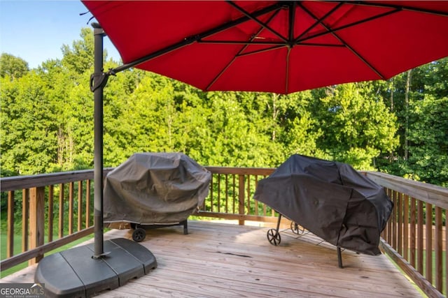 wooden terrace featuring a grill