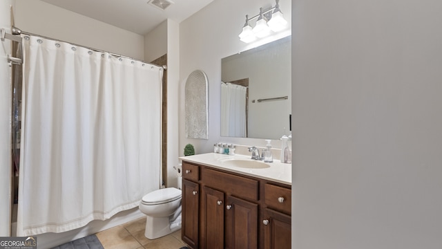 full bathroom with tile patterned floors, vanity, toilet, and shower / bath combo with shower curtain