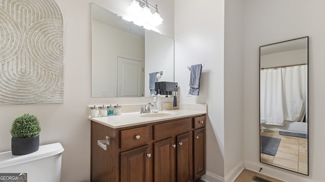 bathroom with vanity and toilet