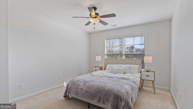 bedroom with ceiling fan and light colored carpet