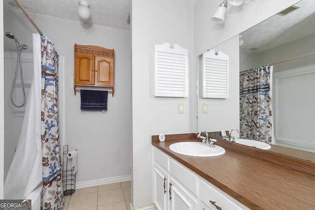 bathroom featuring vanity, tile patterned floors, a textured ceiling, and a shower with shower curtain