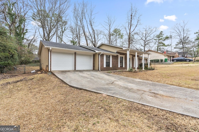 single story home featuring a garage and a front yard