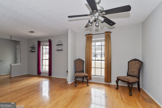 sitting room featuring hardwood / wood-style flooring and a textured ceiling