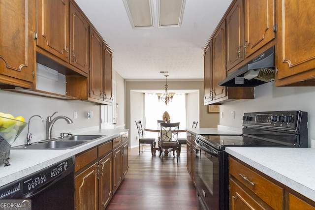 kitchen with sink, black appliances, dark hardwood / wood-style flooring, decorative light fixtures, and a chandelier