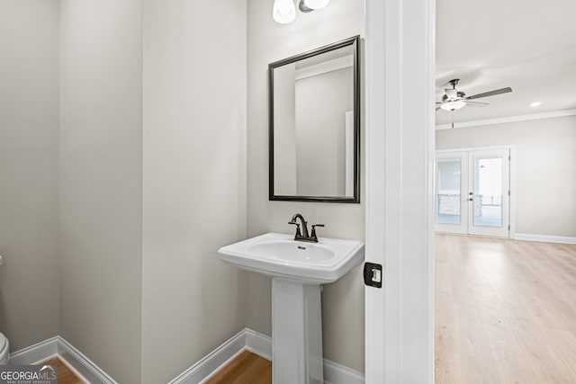 bathroom with sink, ceiling fan, hardwood / wood-style floors, ornamental molding, and toilet