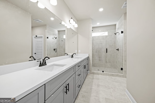 bathroom with a shower with door and vanity