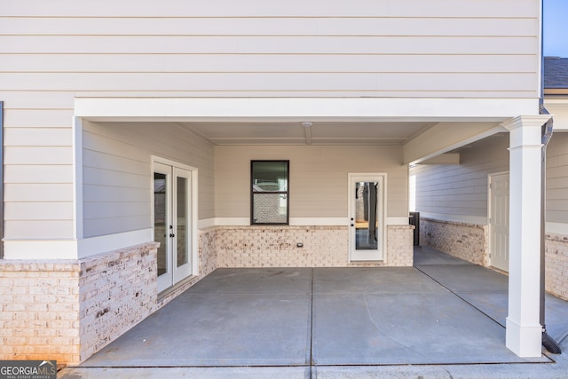 view of exterior entry featuring a patio area