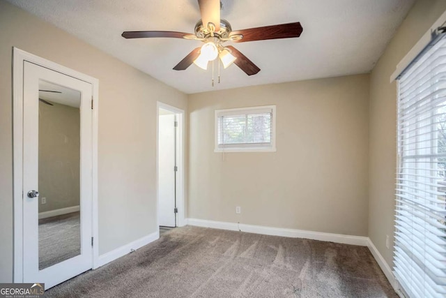 unfurnished bedroom featuring light colored carpet and ceiling fan