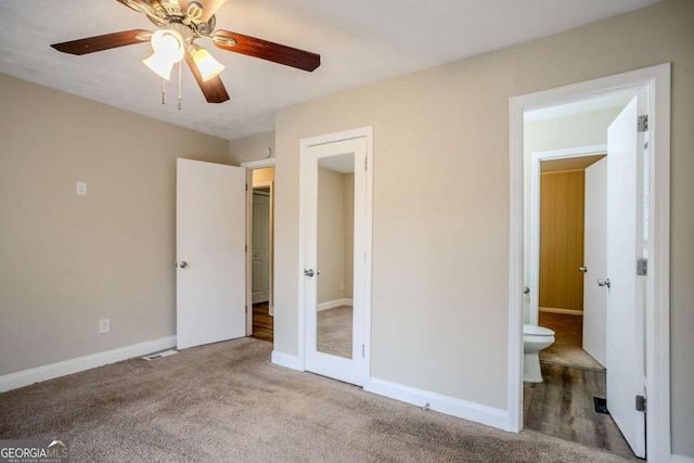 unfurnished bedroom with light colored carpet, ceiling fan, and ensuite bathroom