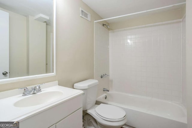 full bathroom with vanity, toilet, and tiled shower / bath combo