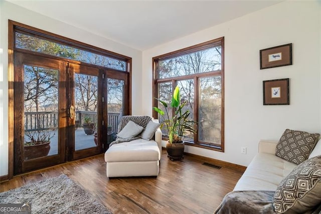 sitting room with dark hardwood / wood-style floors and french doors