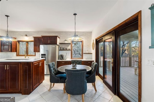 dining space with sink and light tile patterned floors