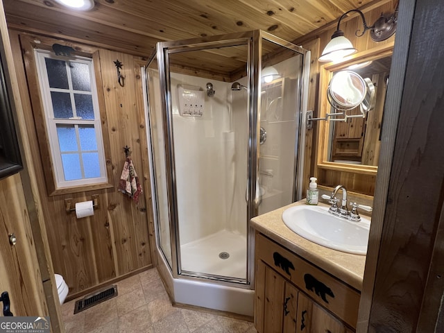 bathroom with walk in shower, wooden ceiling, vanity, and wood walls