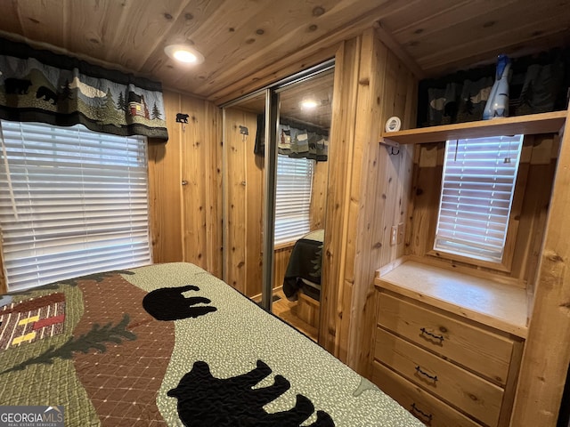 bedroom featuring wooden walls and wood ceiling