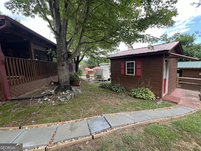 view of home's exterior with a storage shed and a yard