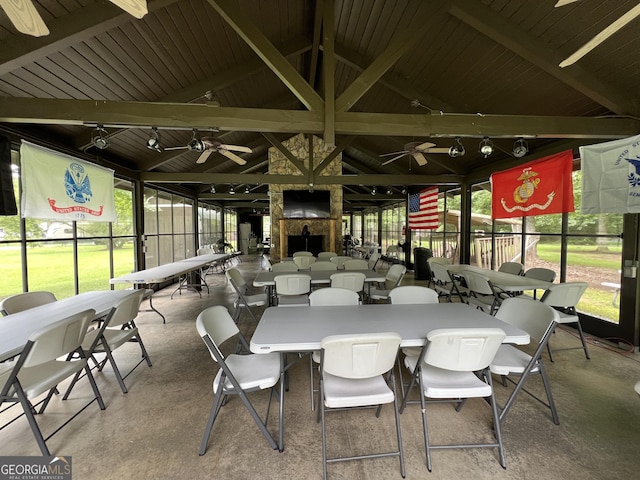 interior space with ceiling fan, a healthy amount of sunlight, and vaulted ceiling with beams