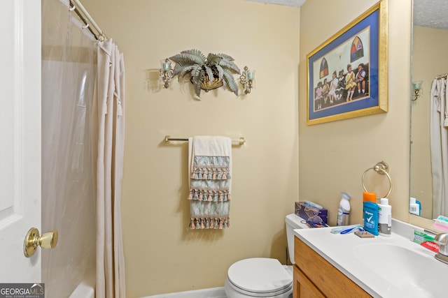 bathroom featuring vanity, toilet, and walk in shower